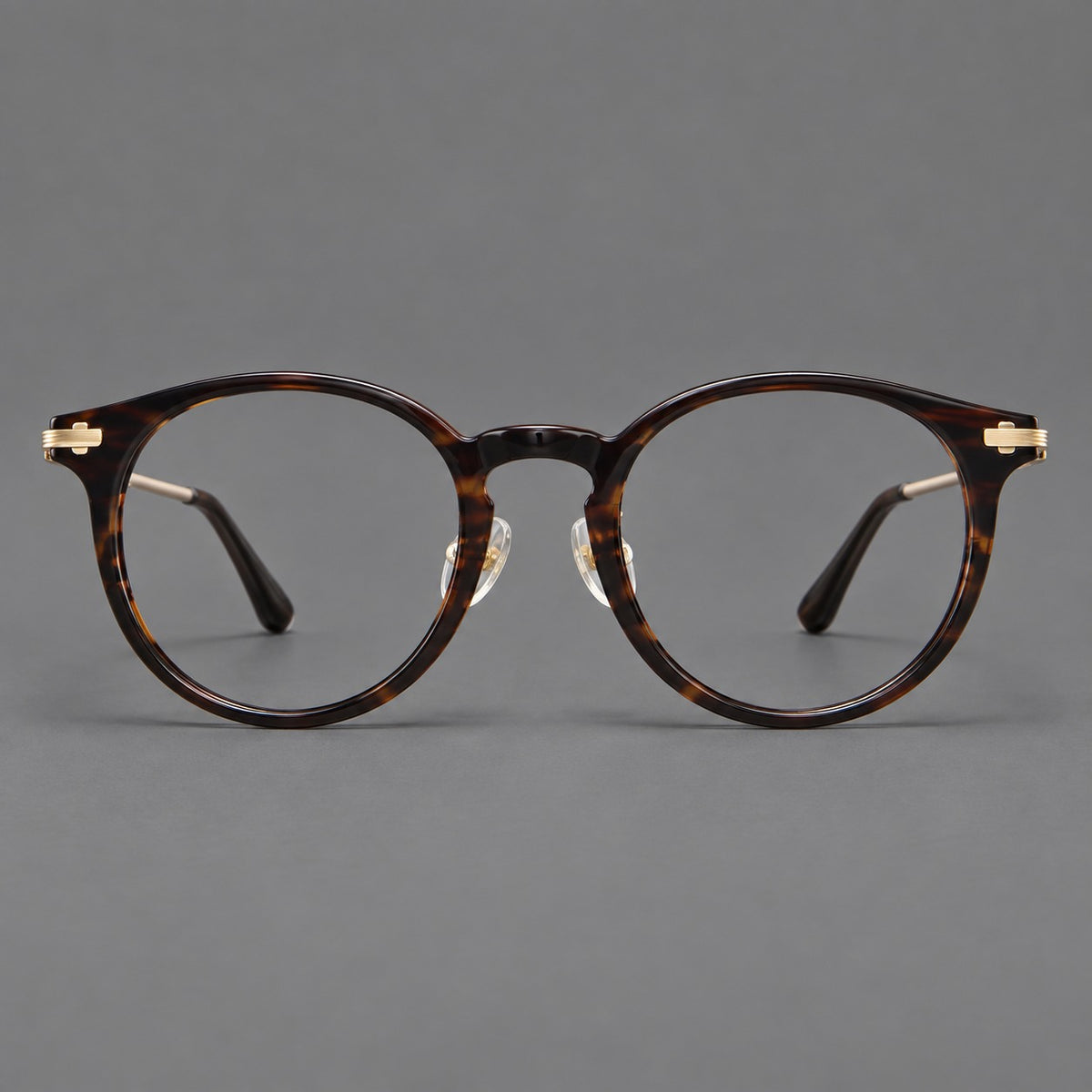 Retro acetate and titanium eyeglasses with round rims and a pronounced keyhole bridge in Brown Woodgrain / Gold, front view
