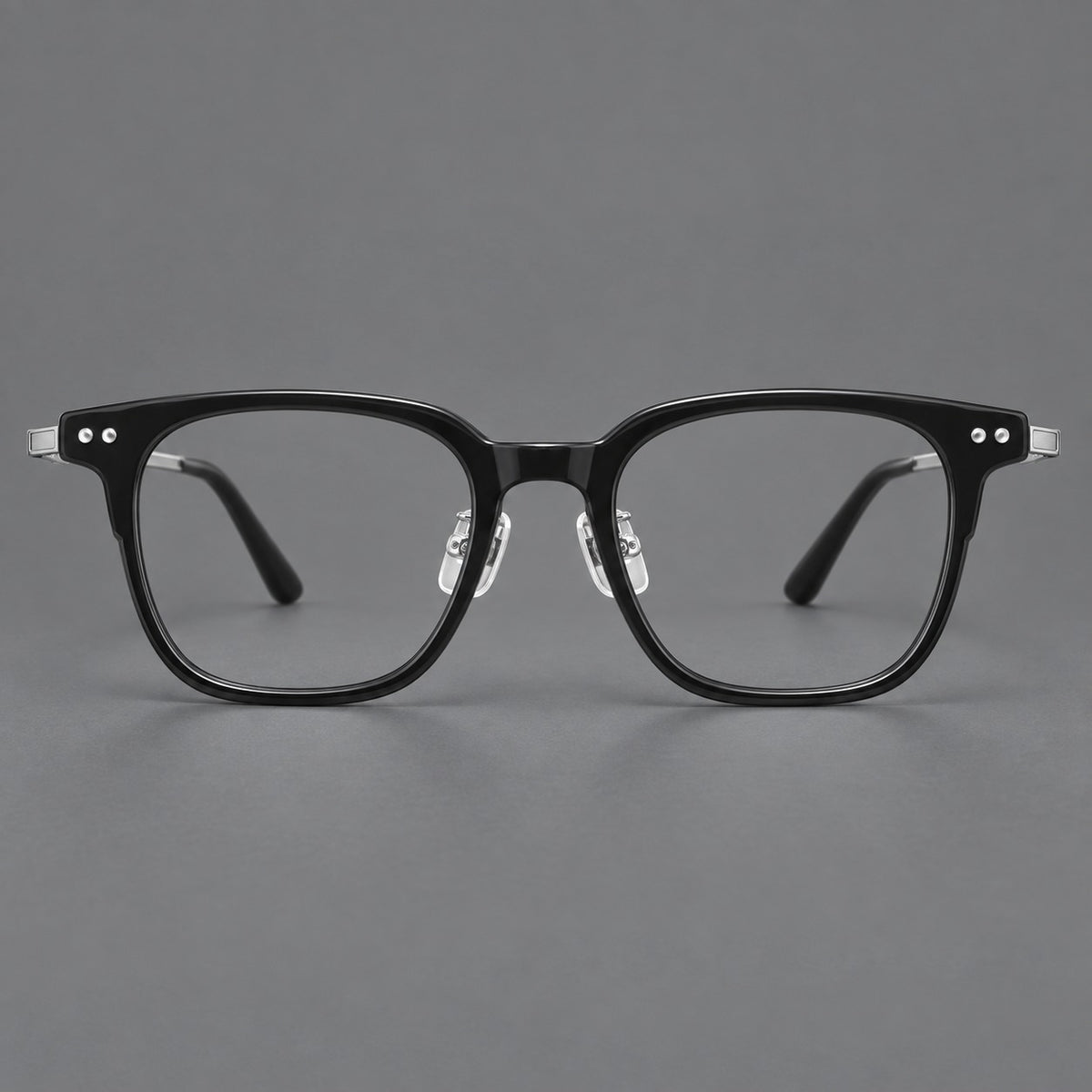Classic acetate and titanium eyeglasses with squared brows and paired corner rivets in Black / Silver, front view