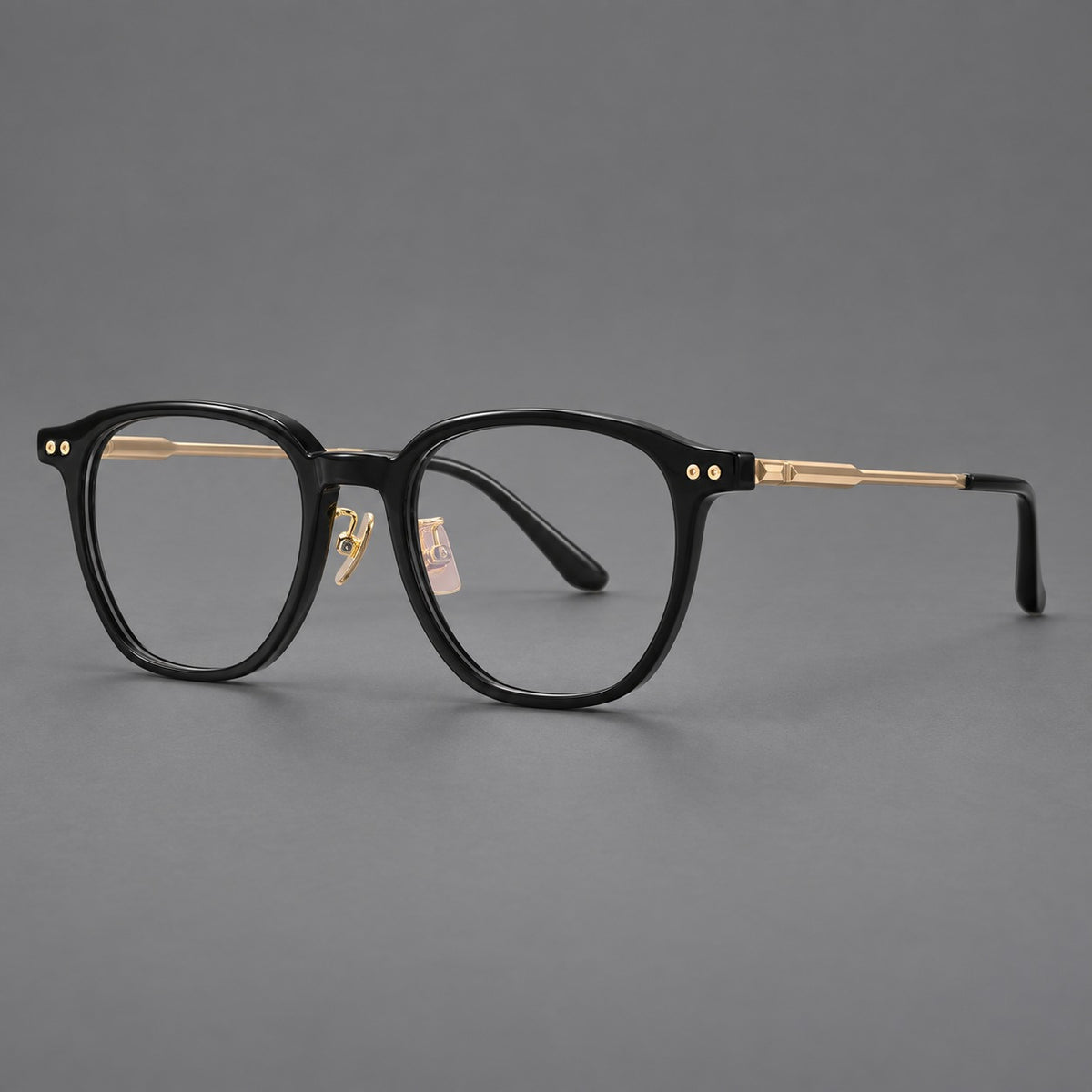 Vintage acetate and titanium eyeglasses with rounded square rims and slotted metal temples in Black / Gold, three quarter view