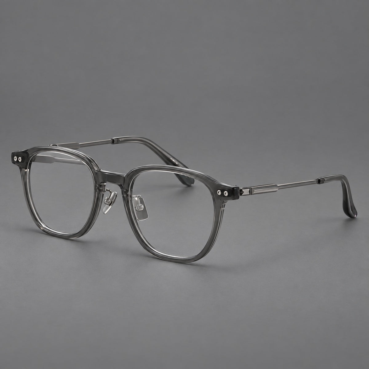 Vintage acetate and titanium eyeglasses with rounded square rims and slotted metal temples in Clear Grey, three quarter view