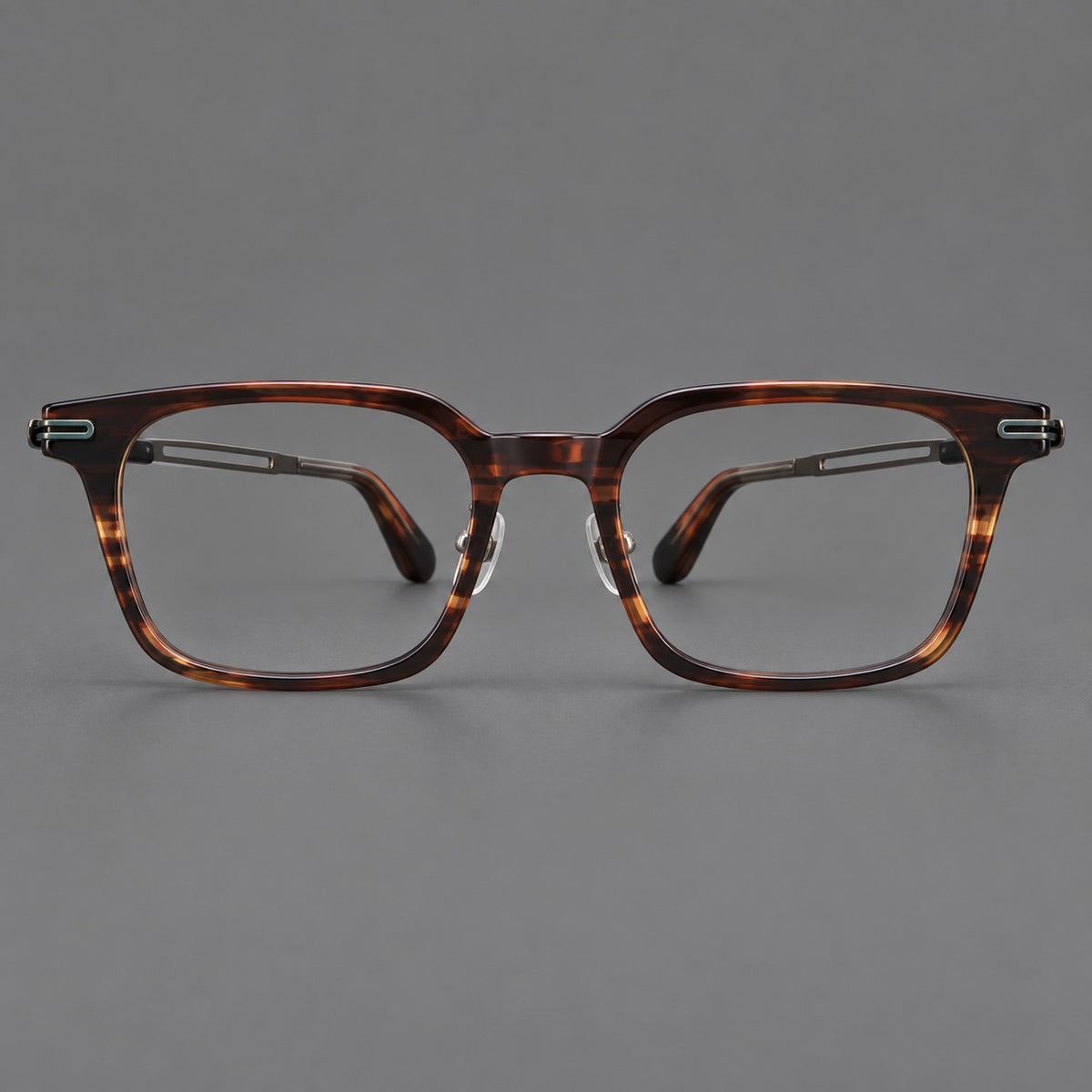 Modern acetate and titanium eyeglasses with angular square rims and curved metal hinges in Striped Brown / Antique Bronze, front view