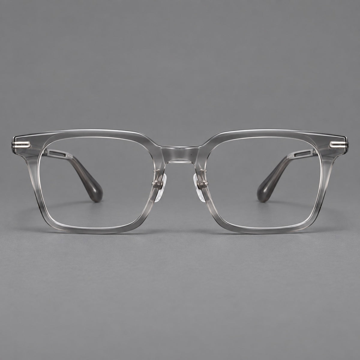 Modern acetate and titanium eyeglasses with angular square rims and curved metal hinges in Clear Grey, front view