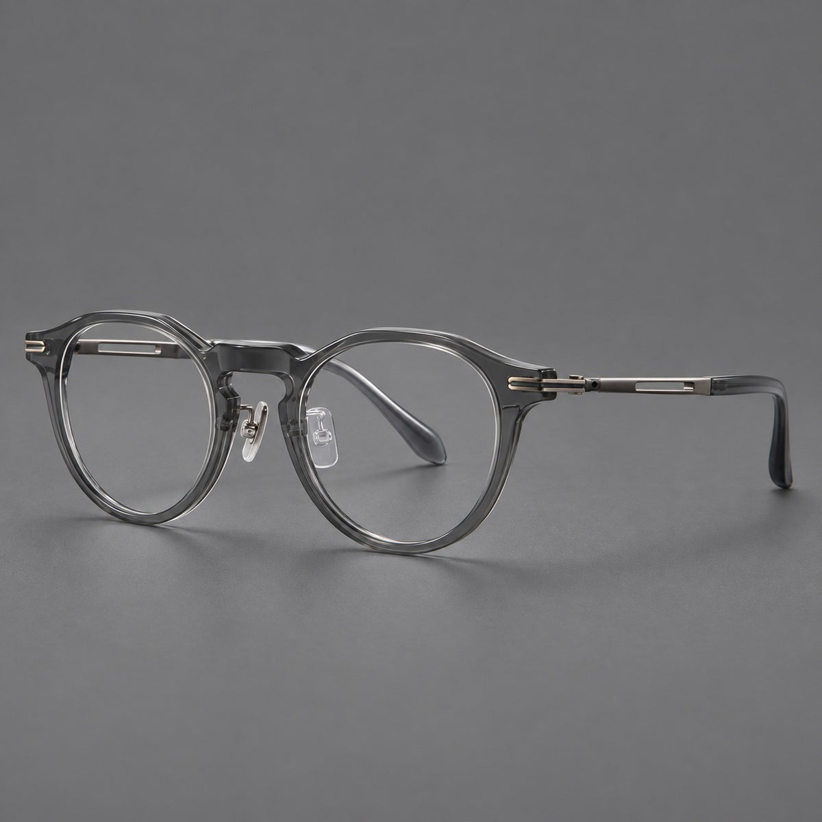 Retro acetate and titanium eyeglasses with round rims and distinctive looped metal joints in Clear Grey / Brushed Grey, three quarter view