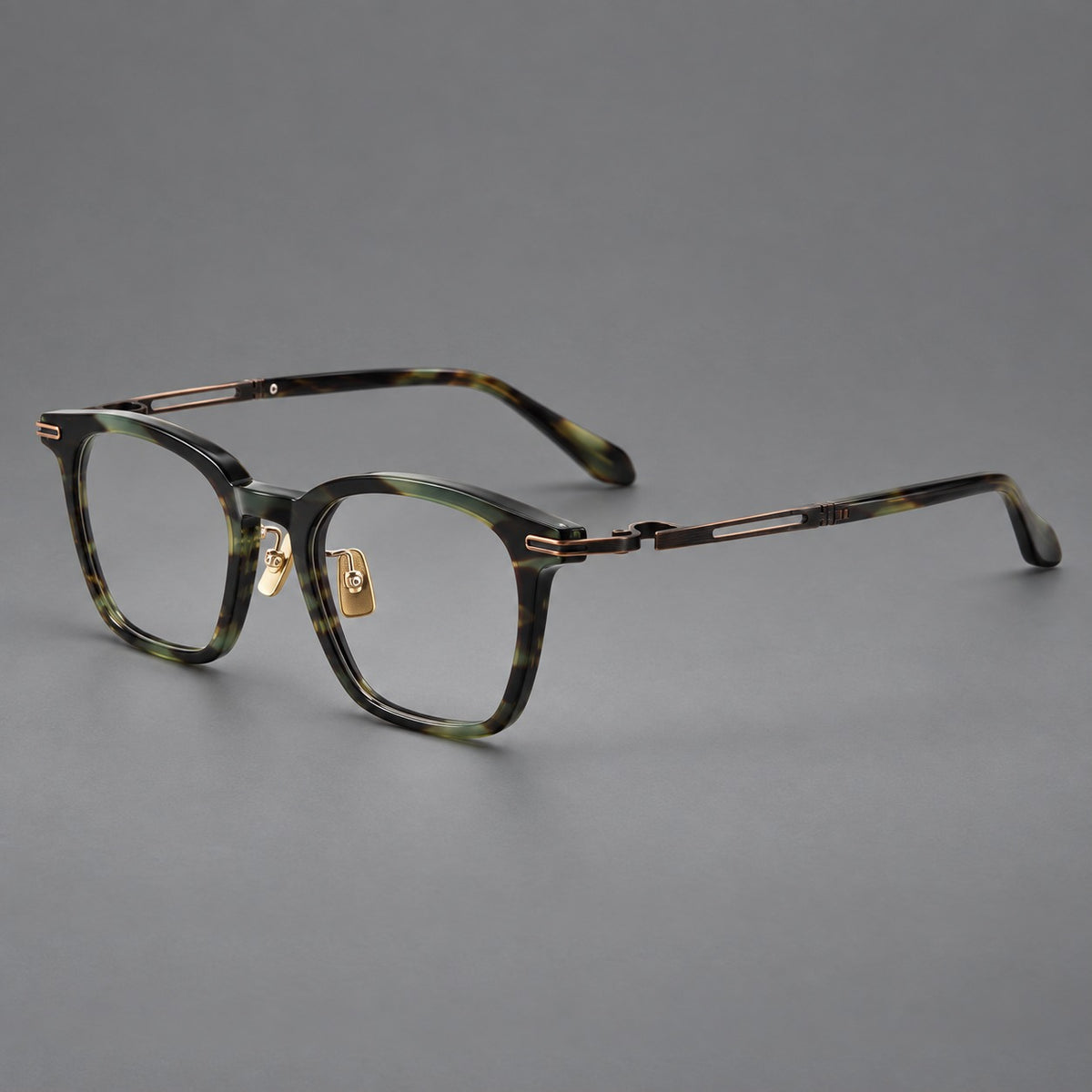 Acetate and titanium eyeglasses with rounded rectangular rims and sculpted open loop joints in Green Tortoiseshell / Antique Bronze, three quarter view