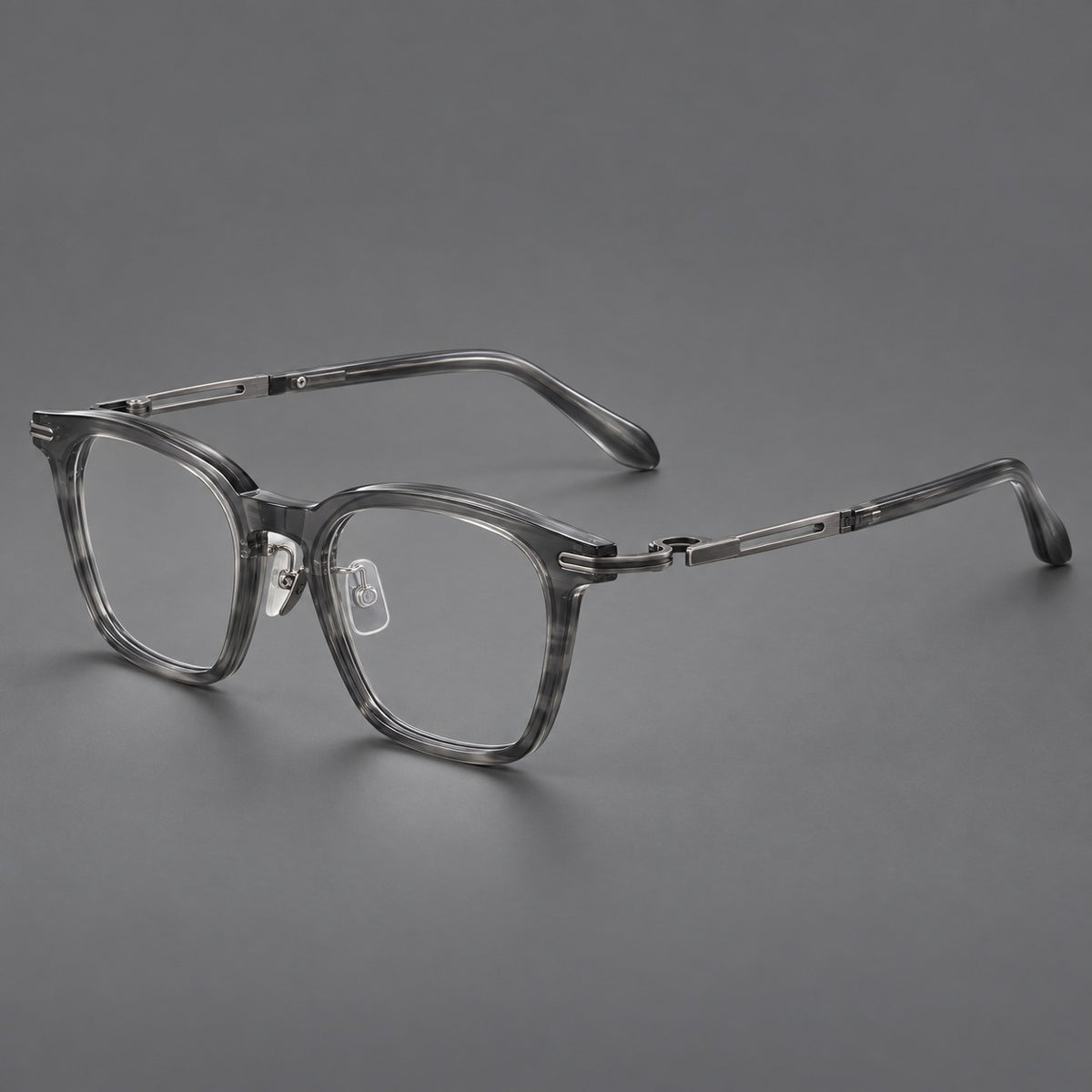 Acetate and titanium eyeglasses with rounded rectangular rims and sculpted open loop joints in Clear Grey / Brushed Grey, three quarter view