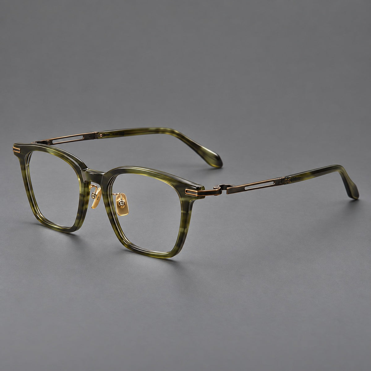 Acetate and titanium eyeglasses with rounded rectangular rims and sculpted open loop joints in Clear Olive Green / Antique Bronze, three quarter view