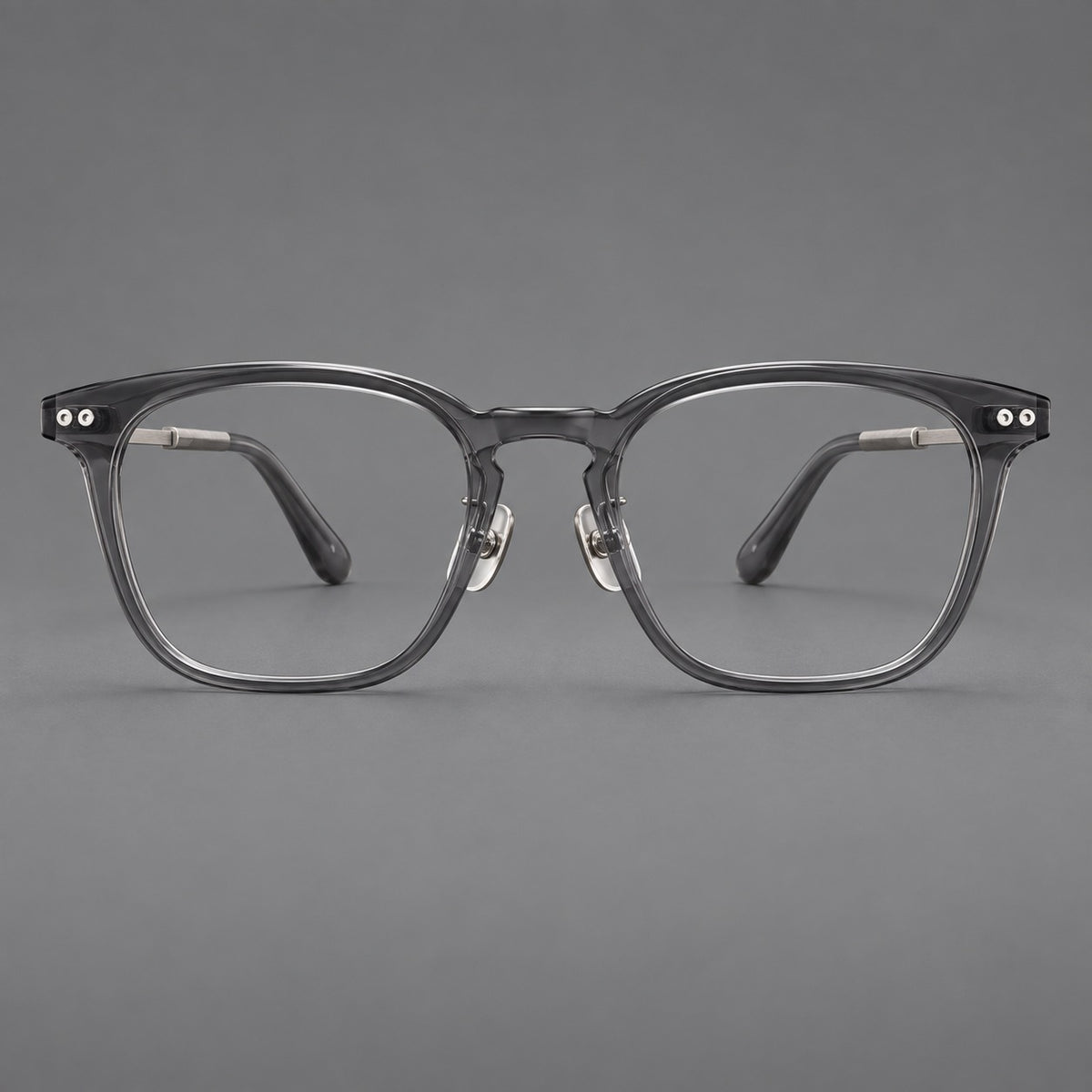 Retro acetate and titanium eyeglasses with gently squared rims and circular metal hinges in Clear Grey / Brushed Grey, front view