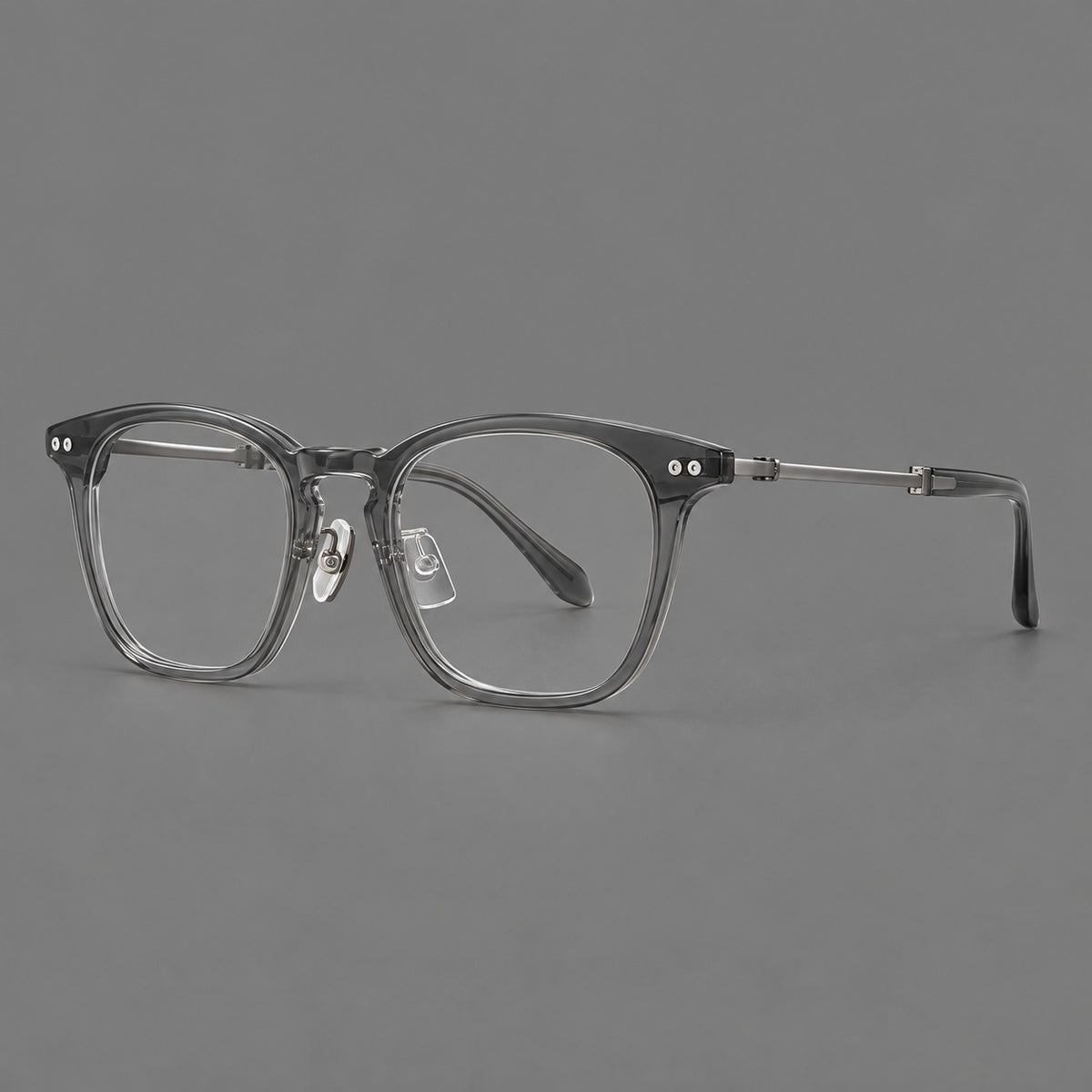 Retro acetate and titanium eyeglasses with gently squared rims and circular metal hinges in Clear Grey / Brushed Grey, three quarter view