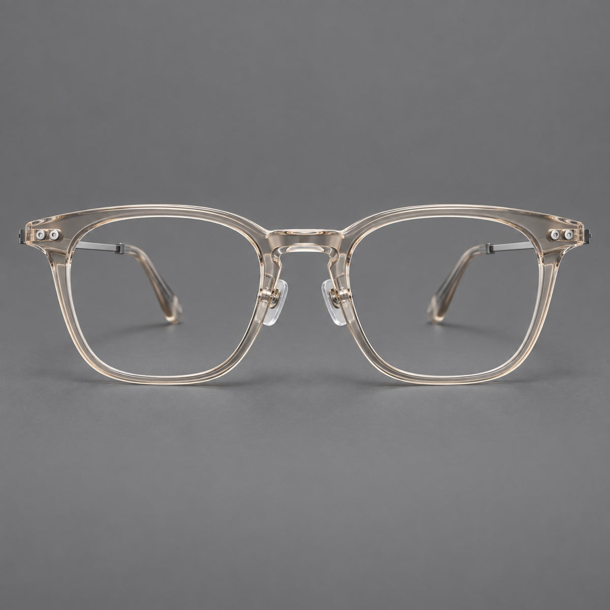 Retro acetate and titanium eyeglasses with gently squared rims and circular metal hinges in Clear Cool Tea / Silver, front view