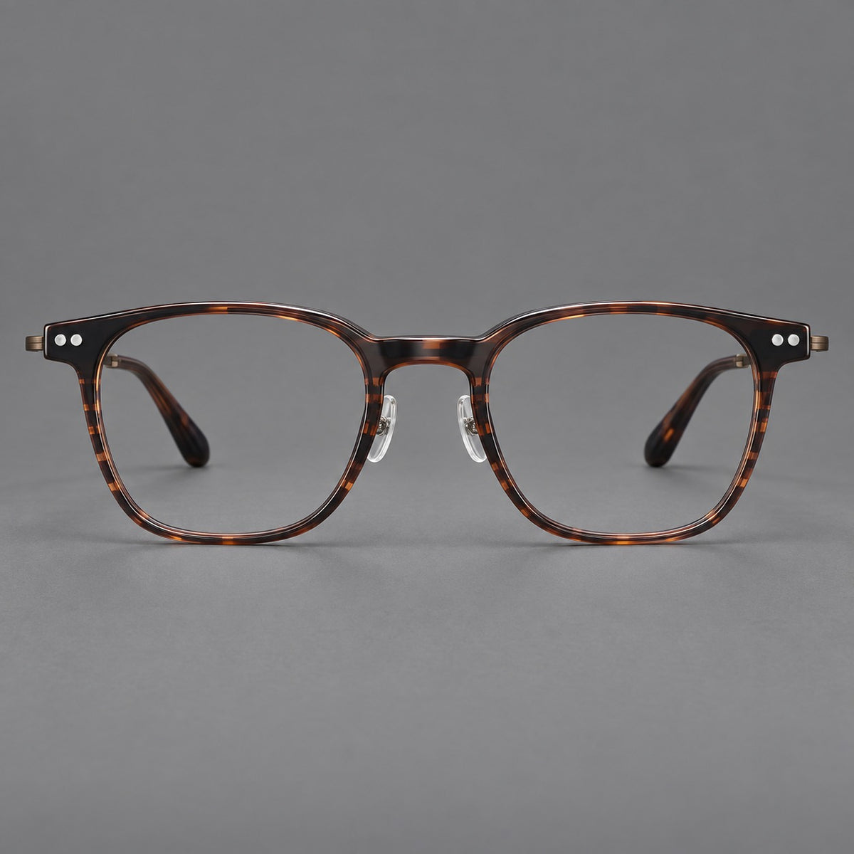 Vintage acetate and titanium eyeglasses with soft square rims and paired metal rivets in Striped Brown / Antique Bronze, front view