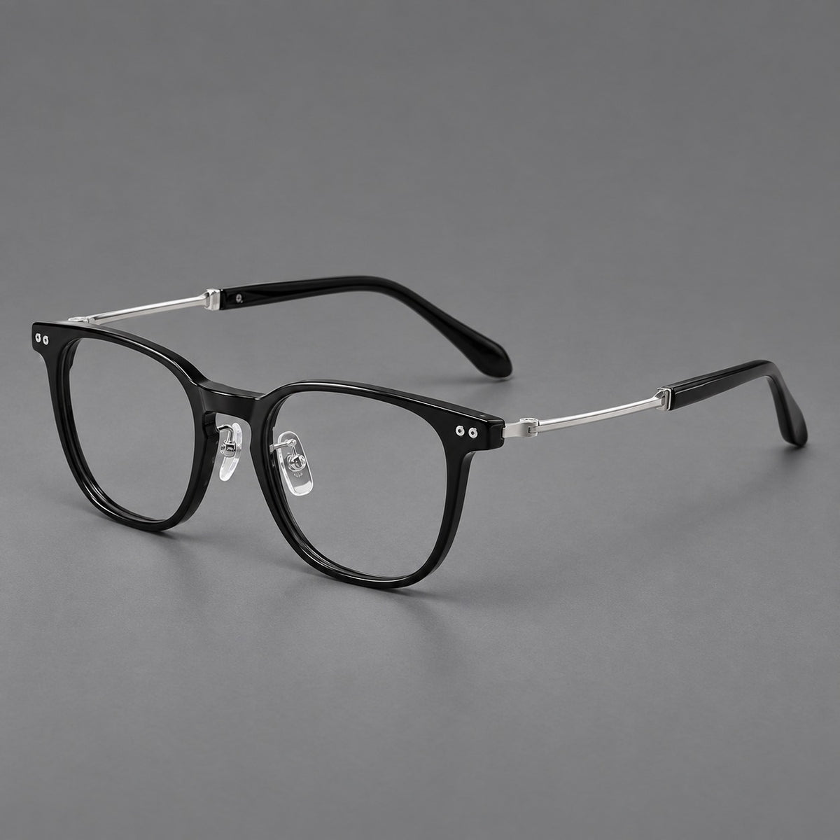 Vintage acetate and titanium eyeglasses with soft square rims and paired metal rivets in Black / Silver, three quarter view