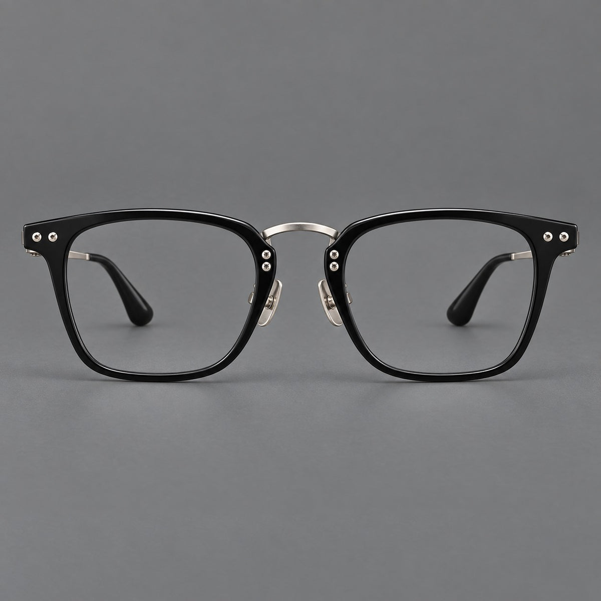 Acetate and titanium eyeglasses with soft square rims and an arched metal bridge in Black / Silver, front view