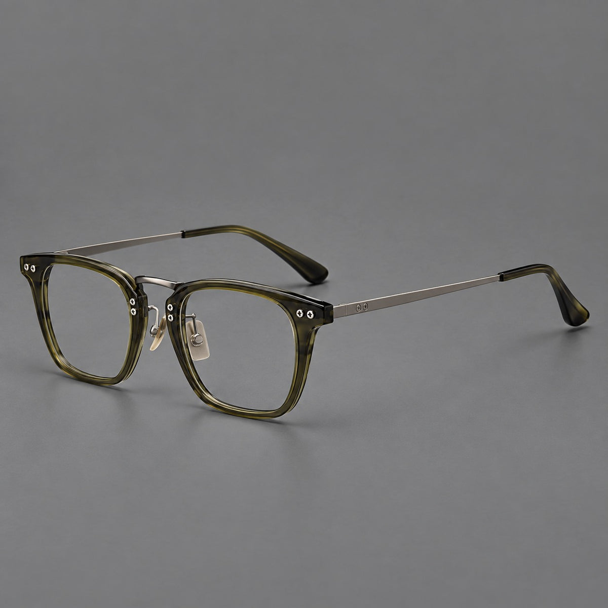 Acetate and titanium eyeglasses with soft square rims and an arched metal bridge in Army Green / Gunmetal, three quarter view