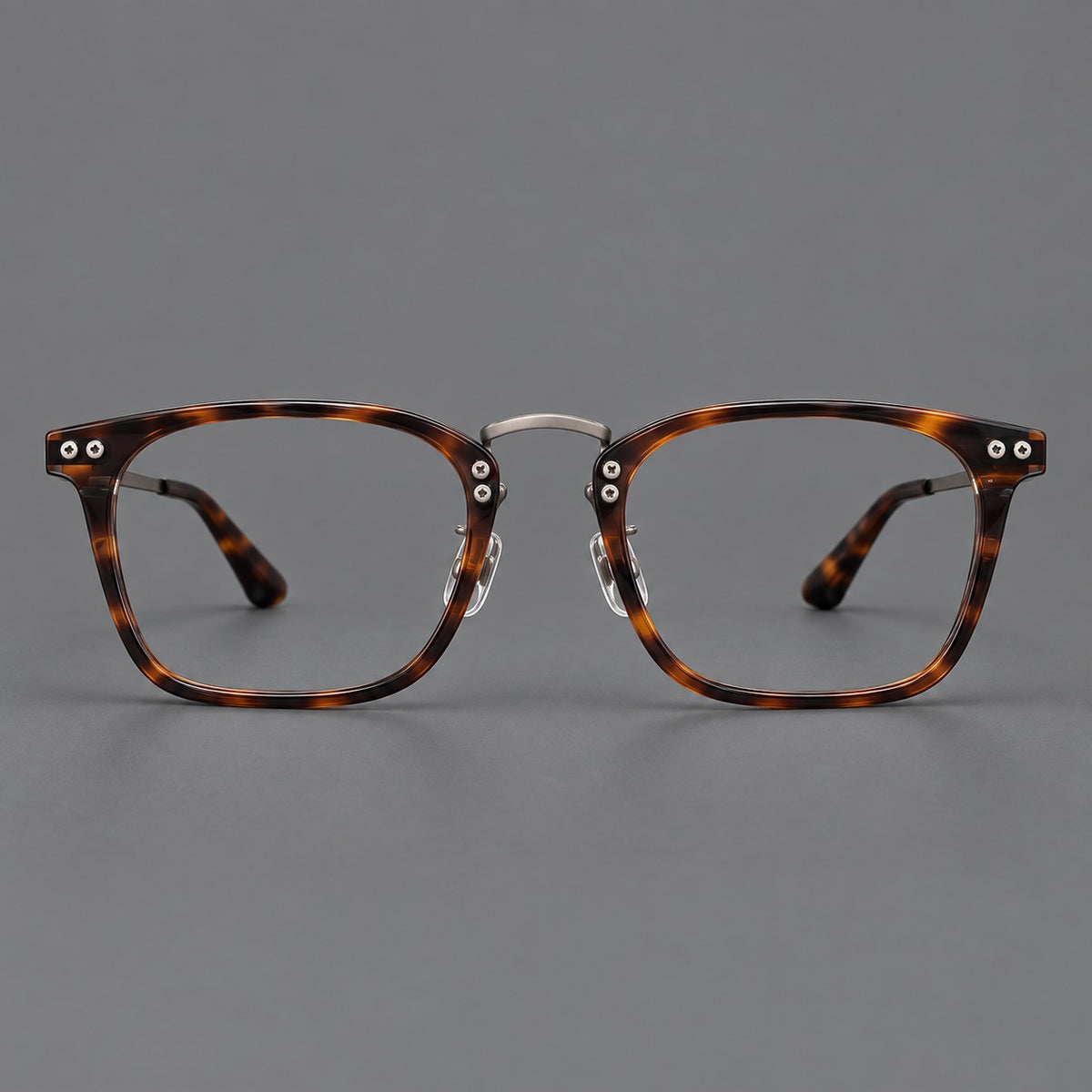Acetate and titanium eyeglasses with angular rectangular rims and a curved metal bridge in Tortoiseshell / Gunmetal, front view