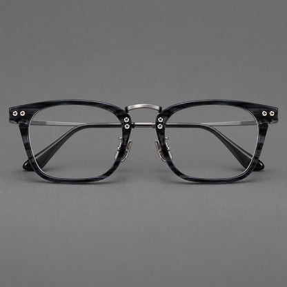 Acetate and titanium eyeglasses with angular rectangular rims and a curved metal bridge in Grey Blue Woodgrain / Gunmetal, front view frame detail