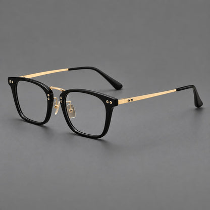 Acetate and titanium eyeglasses with angular rectangular rims and a curved metal bridge in Black / Gold, three quarter view lens detail