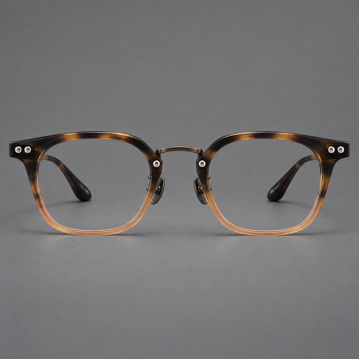 Retro acetate and titanium eyeglasses with softly rounded rims and a metal bridge in Tortoiseshell / Gunmetal, front view
