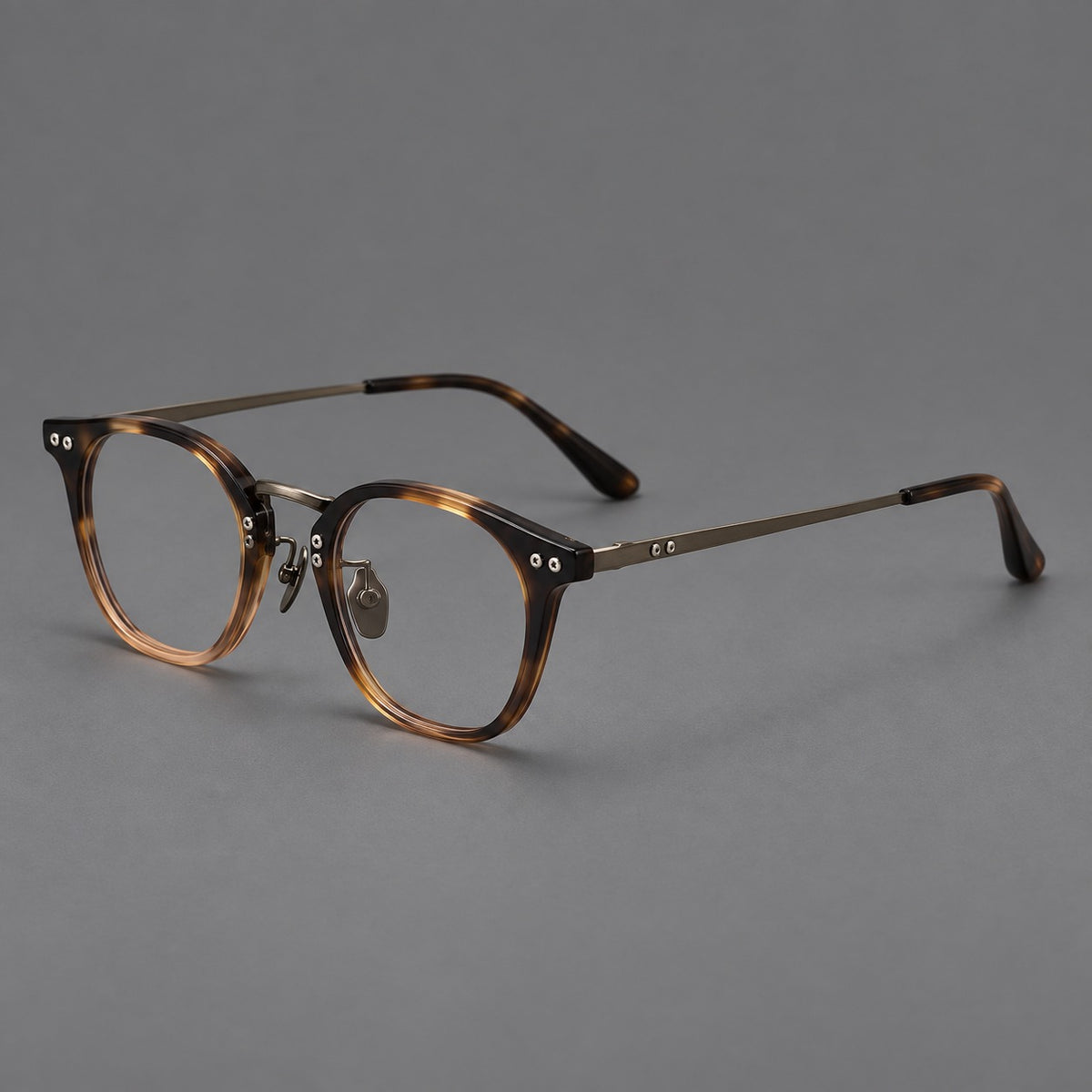 Retro acetate and titanium eyeglasses with softly rounded rims and a metal bridge in Tortoiseshell / Gunmetal, three quarter view