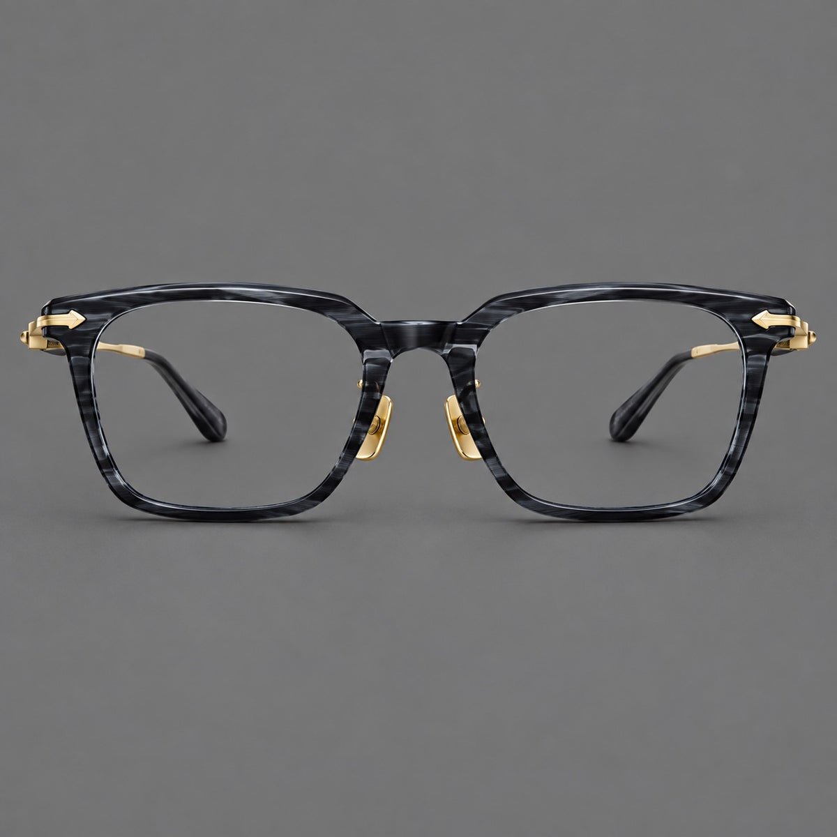 Bold acetate and titanium eyeglasses with rectangular rims and sculpted arrow accents in Grey Blue Woodgrain / Light Gold, front view