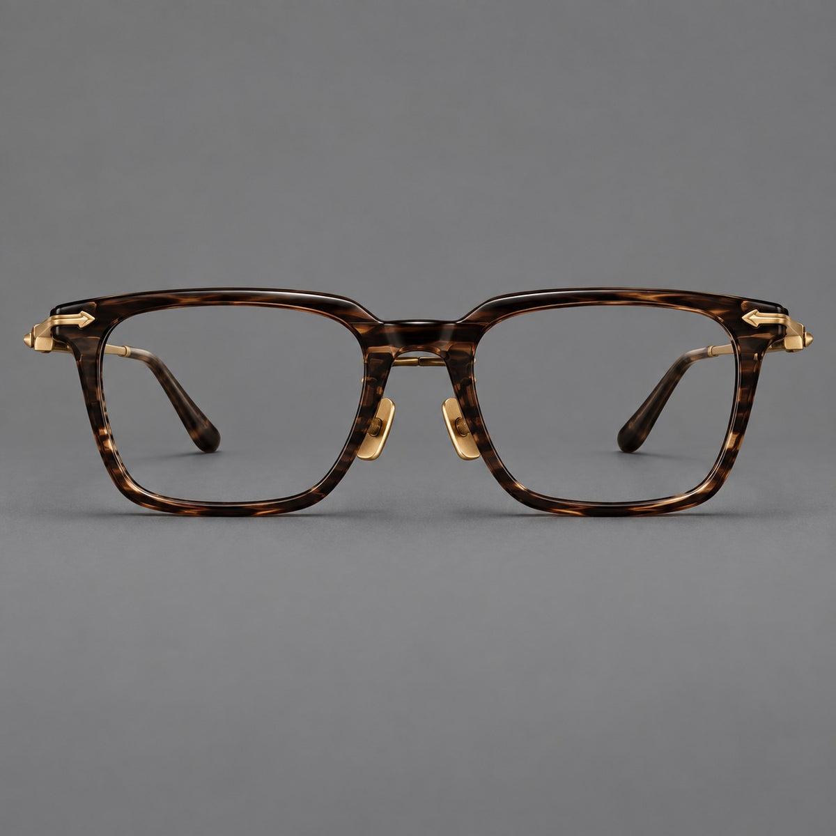 Bold acetate and titanium eyeglasses with rectangular rims and sculpted arrow accents in Tea Woodgrain / Antique Bronze, front view