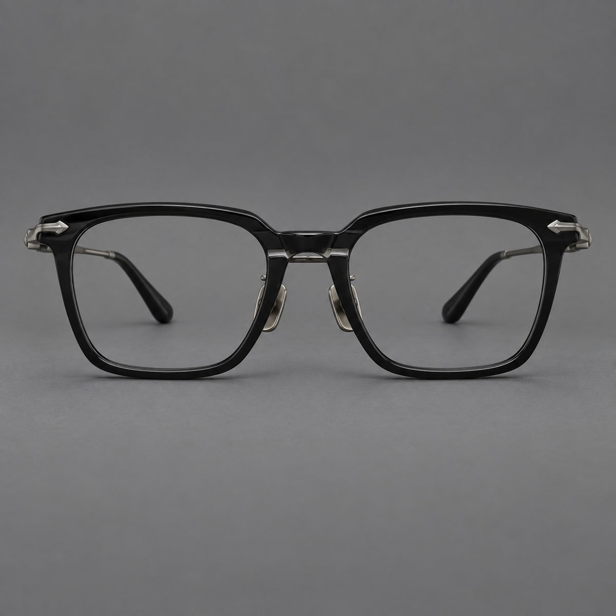 Bold acetate and titanium eyeglasses with rectangular rims and sculpted arrow accents in Black / Gunmetal, front view