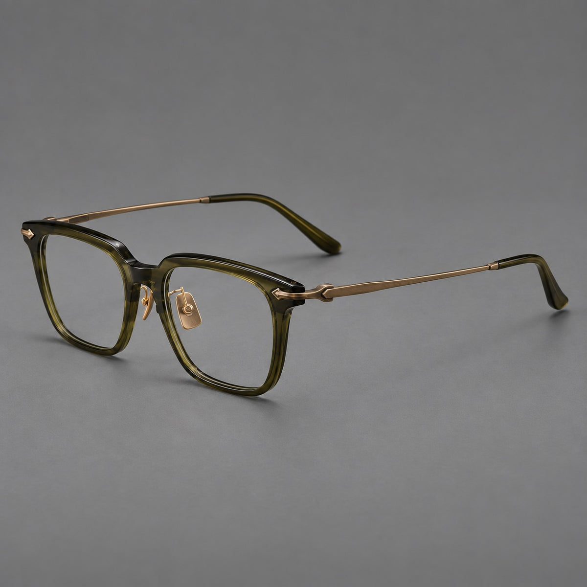 Bold acetate and titanium eyeglasses with rectangular rims and sculpted arrow accents in Army Green / Antique Bronze, three quarter view