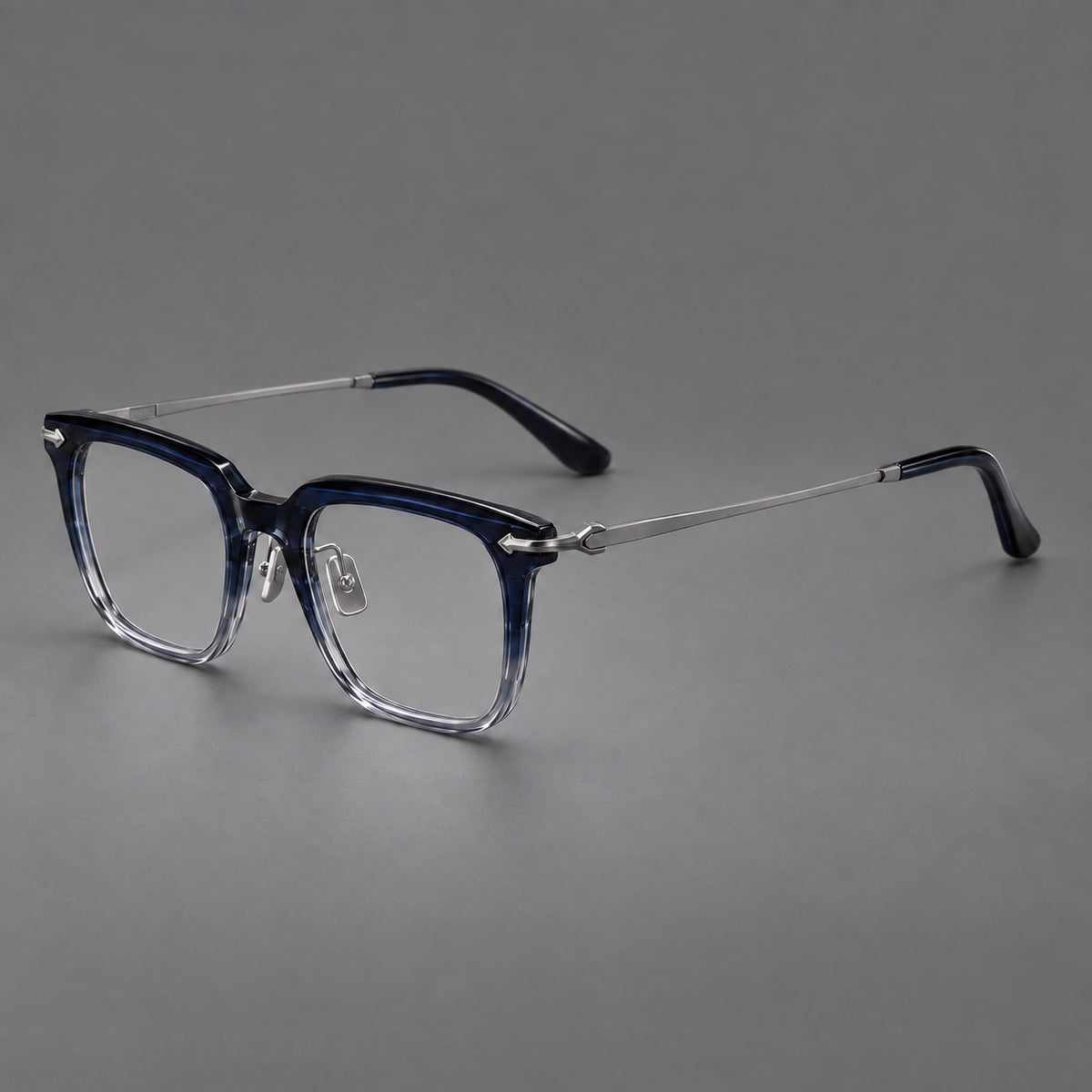 Bold acetate and titanium eyeglasses with rectangular rims and sculpted arrow accents in Blue Gradient / Silver Grey, three quarter view