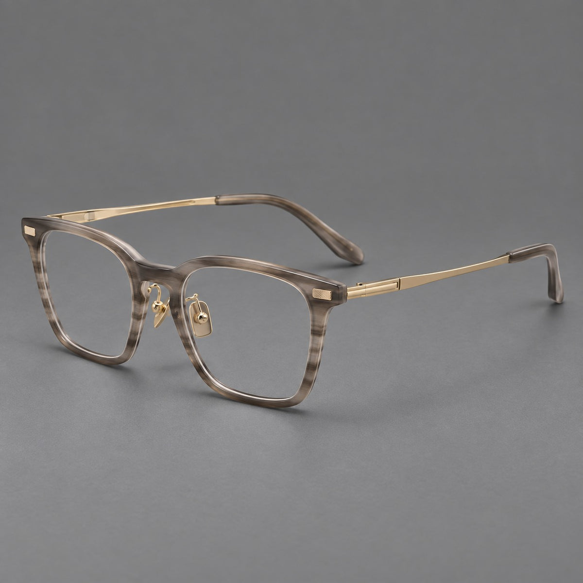 Classic acetate and titanium eyeglasses with rounded square rims and textured corner accents in Grey Woodgrain / Light Gold, three quarter view