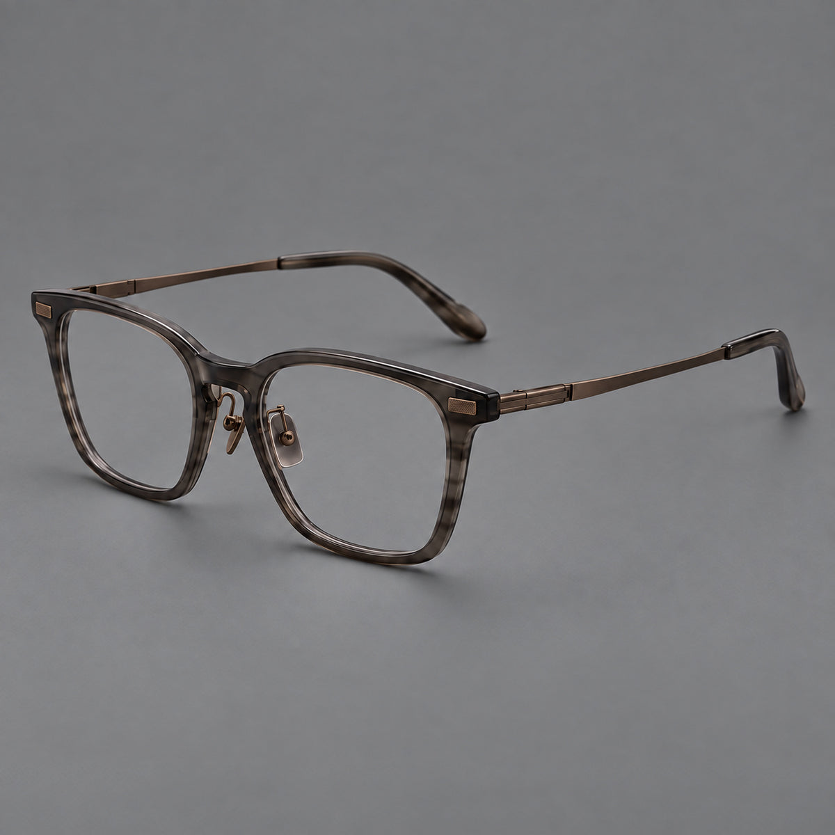 Classic acetate and titanium eyeglasses with rounded square rims and textured corner accents in Dark Grey / Antique Bronze, three quarter view