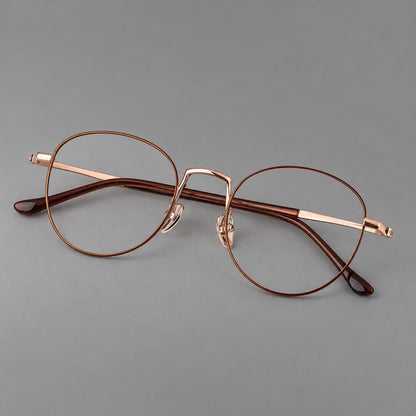 Retro round titanium glasses with a raised bridge and smooth corner shoulders in Brown and Rose Gold, three quarter view front view