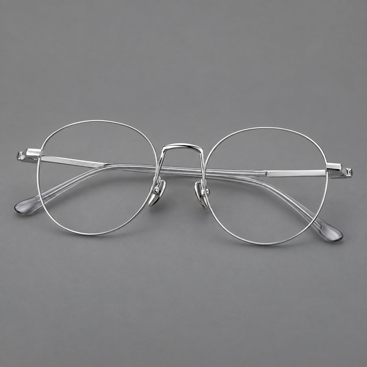 Retro round titanium glasses with a raised bridge and smooth corner shoulders in Silver, three quarter view