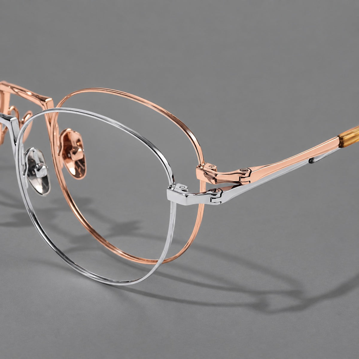 Retro round titanium glasses with a raised bridge and smooth corner shoulders, frame details