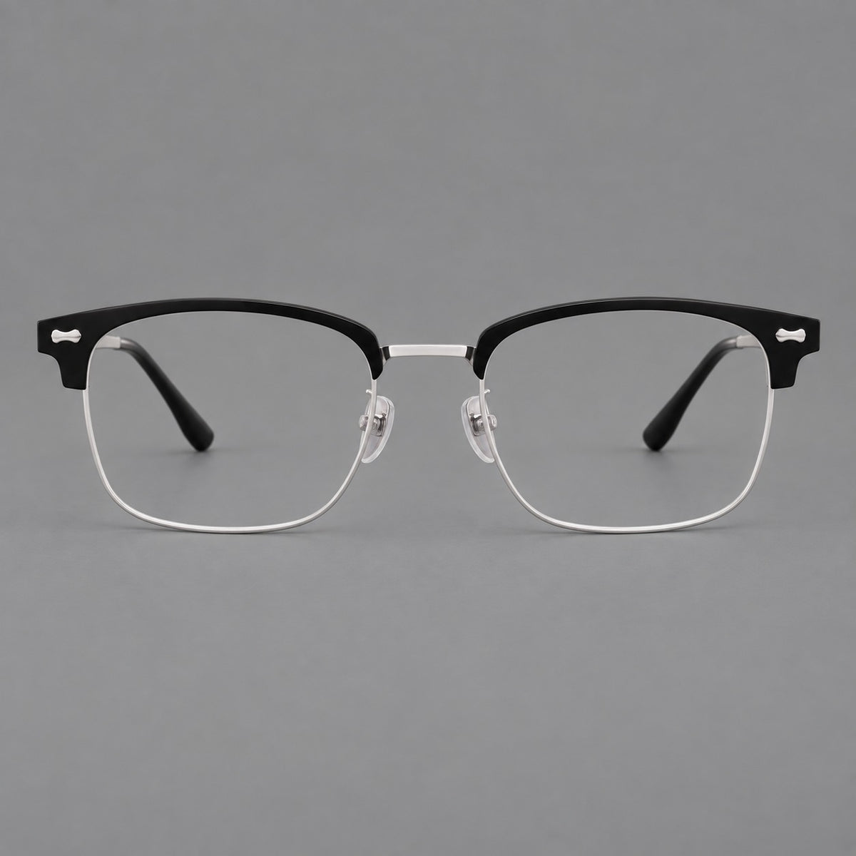 Classic browline titanium glasses with fine lower rims and subtle corner accents in Black and Silver, front view