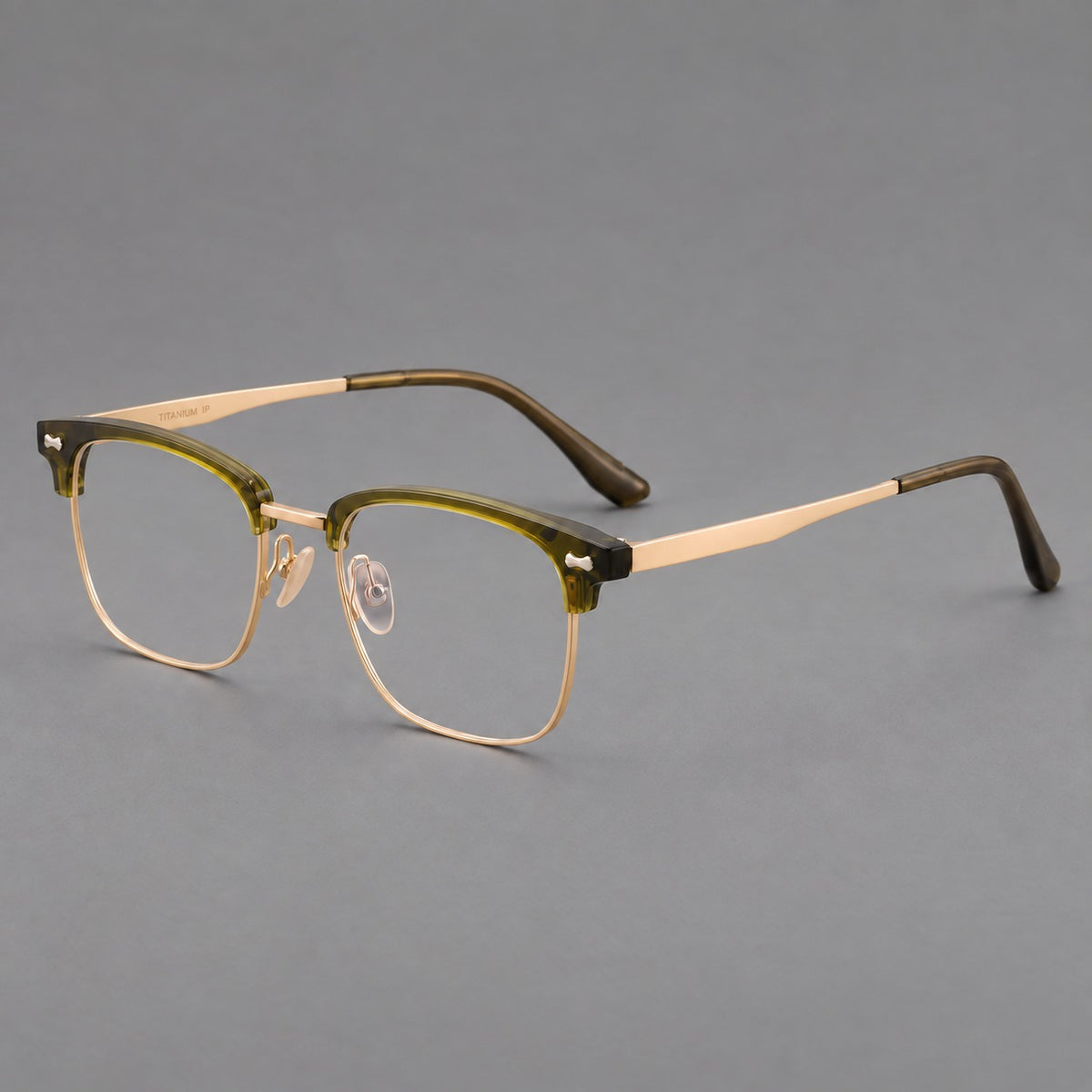 Classic browline titanium glasses with fine lower rims and subtle corner accents in Green and Gold, three quarter view