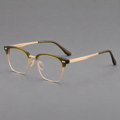 Classic browline titanium glasses with fine lower rims and subtle corner accents in Green and Gold, three quarter view lens detail
