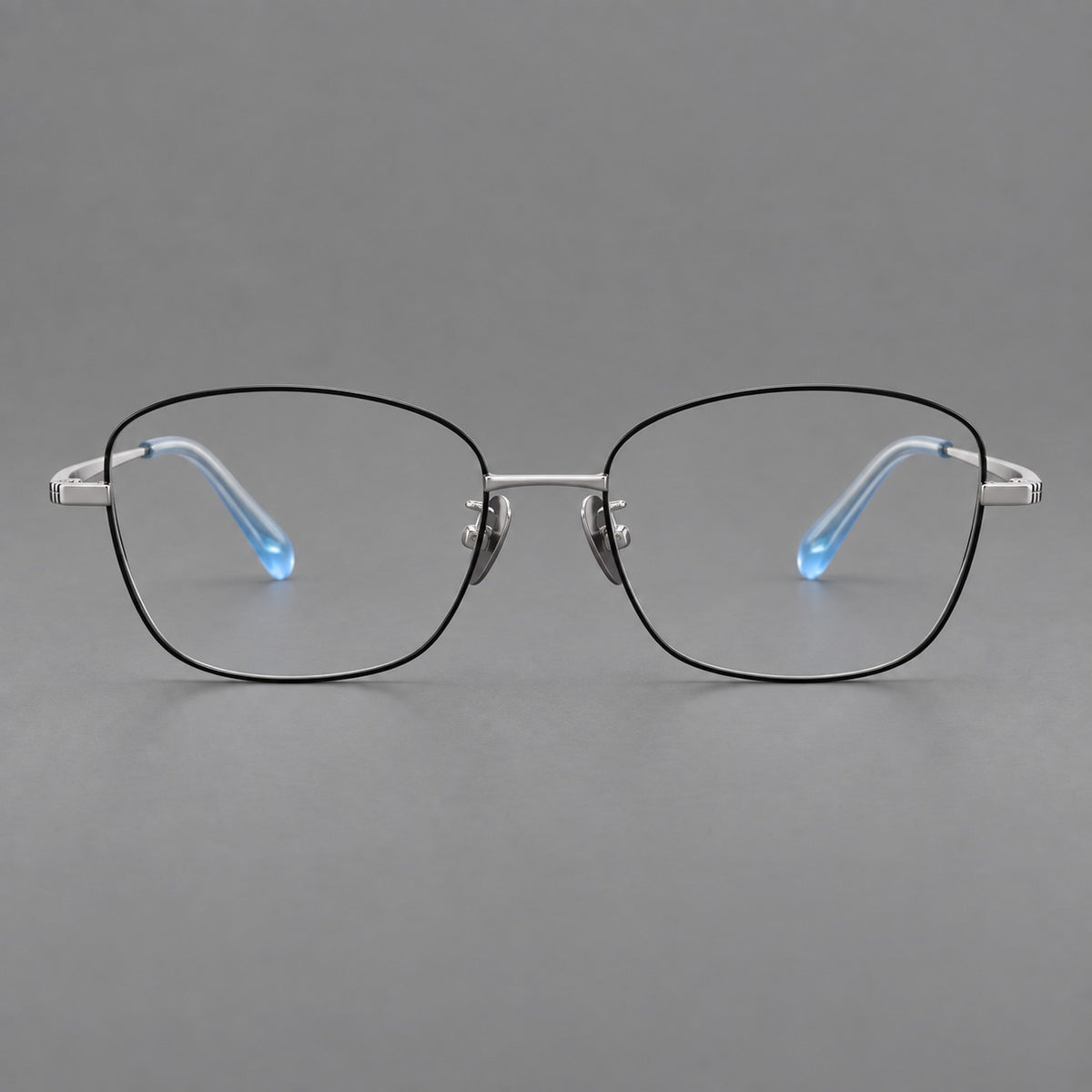 Soft square titanium glasses with angled upper corners and decorated hinges in Black and Silver, front view