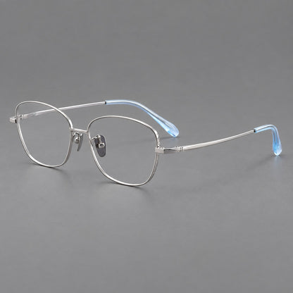 Soft square titanium glasses with angled upper corners and decorated hinges in Silver, three quarter view lens detail