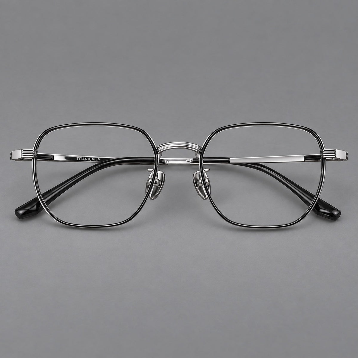 Retro square titanium glasses with rounded rims and finely grooved shoulders in Black and Silver, front view
