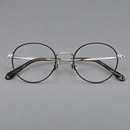 Rounded panto titanium glasses with a raised bridge and dotted temple accents in Black and Silver, front view temple detail