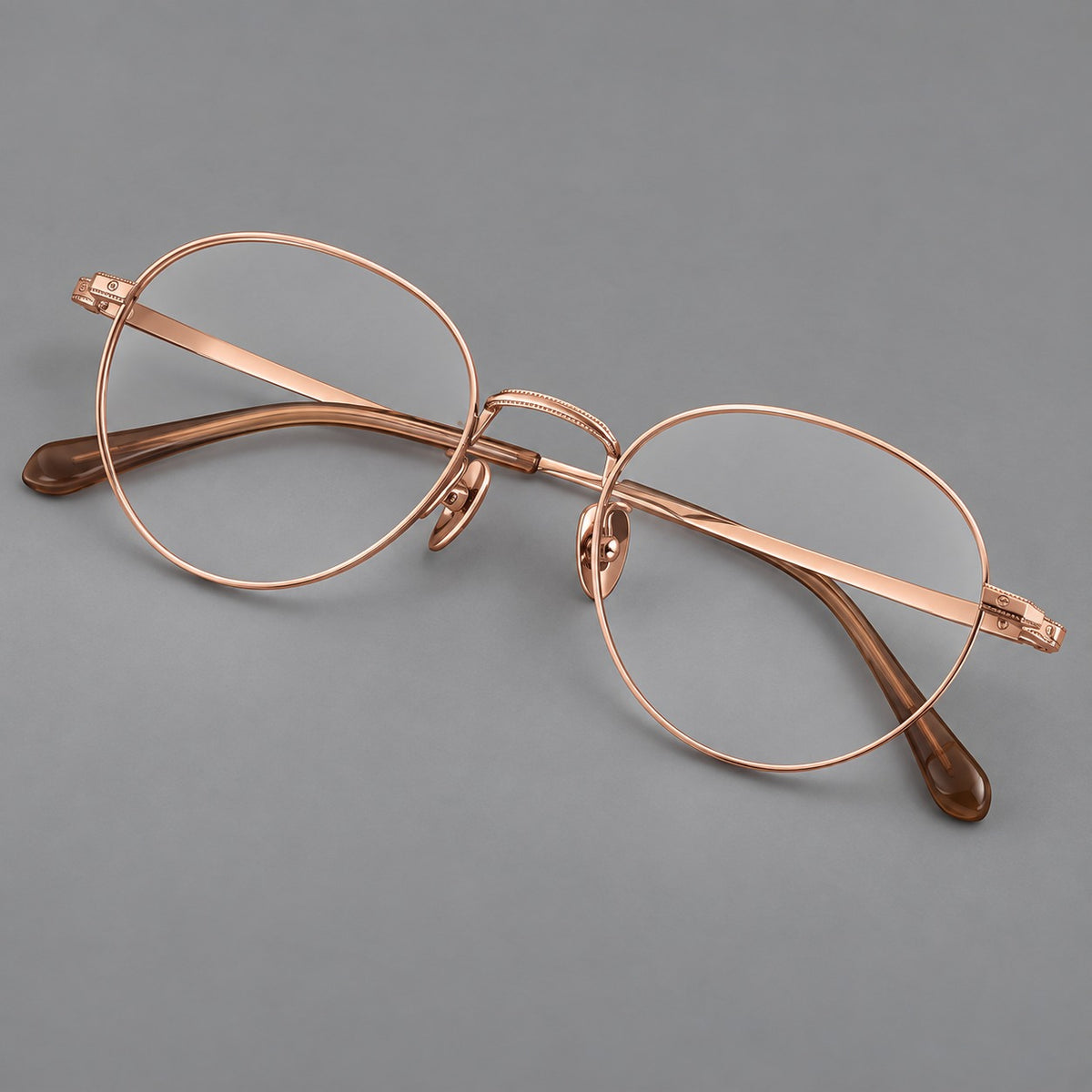 Rounded panto titanium glasses with a raised bridge and dotted temple accents in Rose Gold, three quarter view