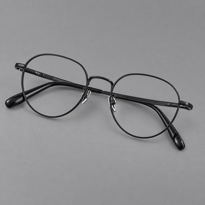 Classic round titanium glasses with broad flat temples and inset hinge details in Black, three quarter view