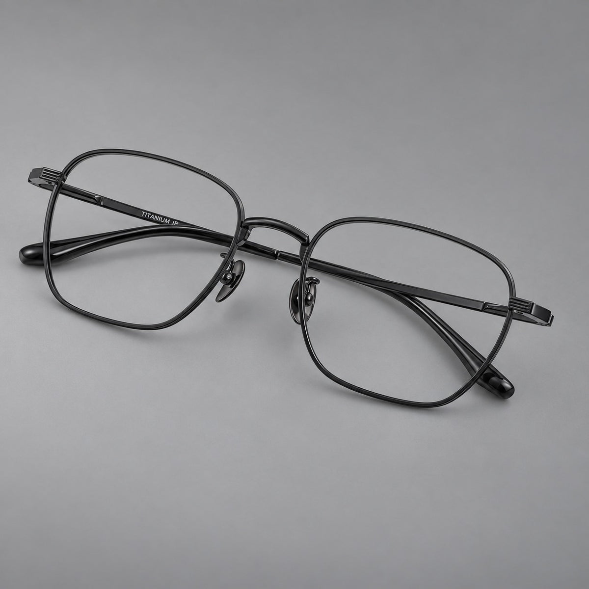 Deep square titanium glasses with a flatter brow and grooved outer shoulders in Black, three quarter view