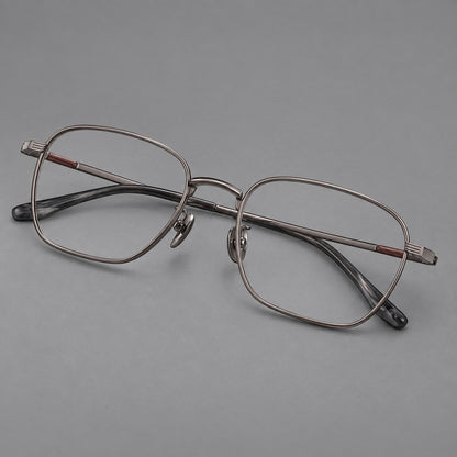 Deep square titanium glasses with a flatter brow and grooved outer shoulders in Gunmetal, three quarter view front view