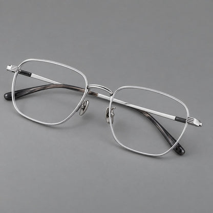 Deep square titanium glasses with a flatter brow and grooved outer shoulders in Black and Silver, three quarter view lens detail
