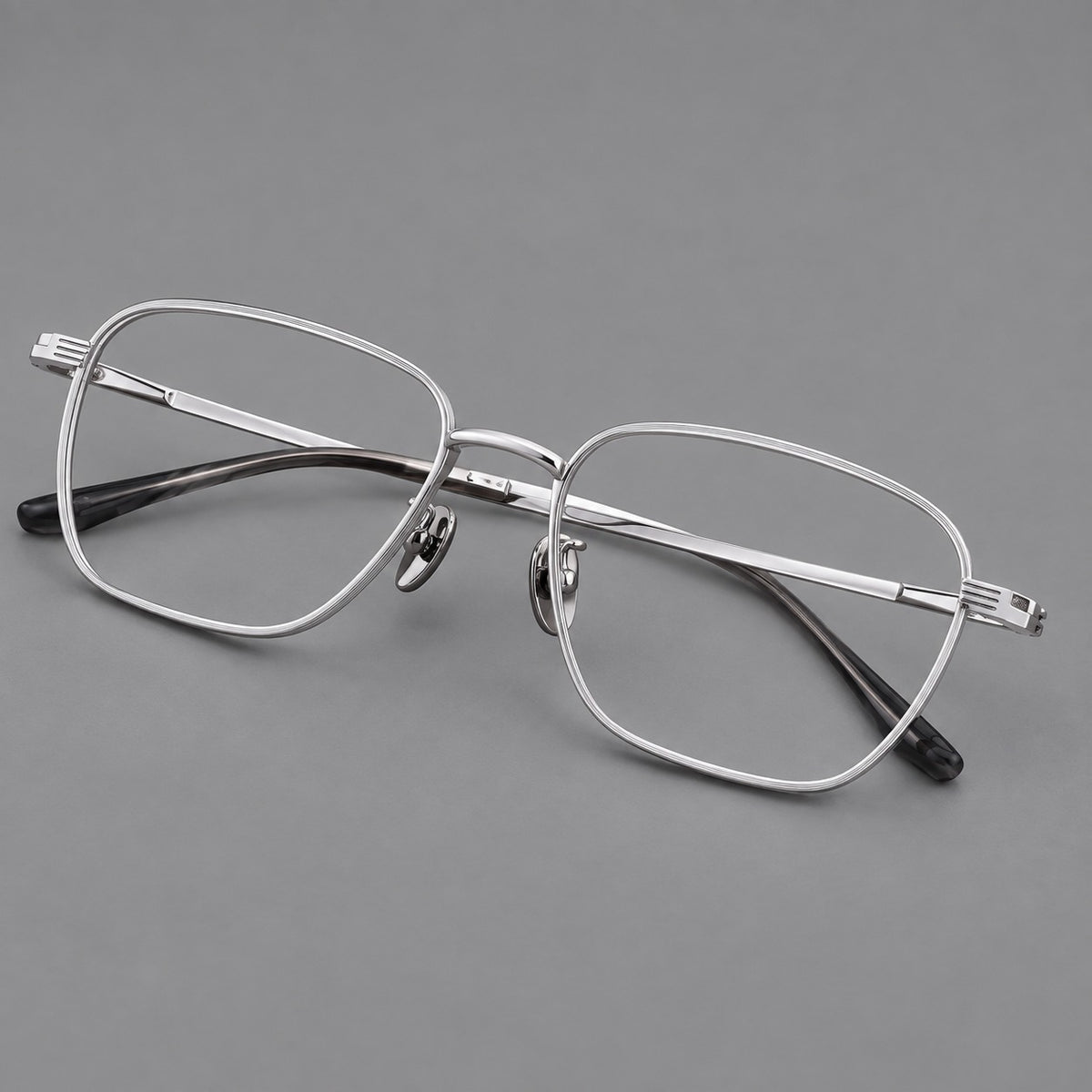 Deep square titanium glasses with a flatter brow and grooved outer shoulders in Silver, three quarter view