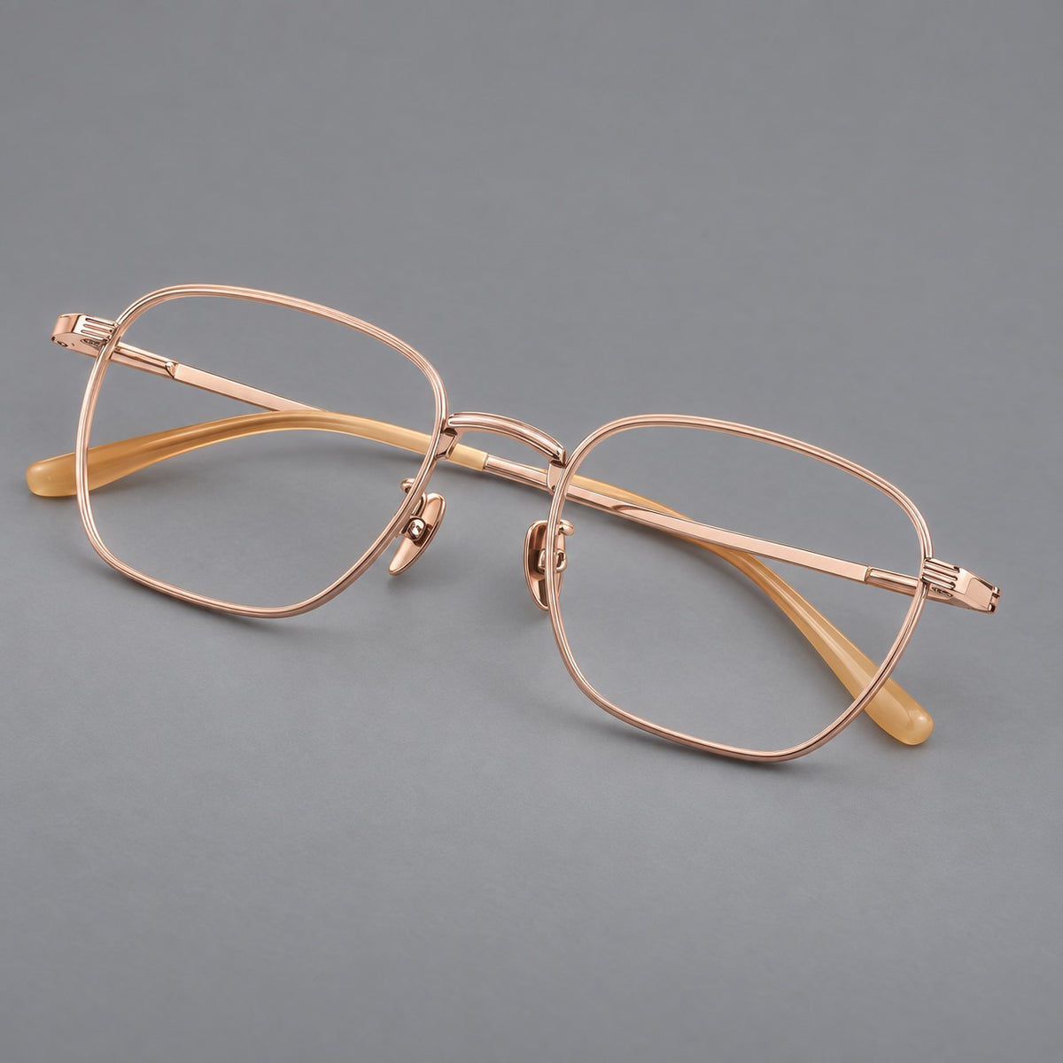 Deep square titanium glasses with a flatter brow and grooved outer shoulders in Rose Gold, three quarter view