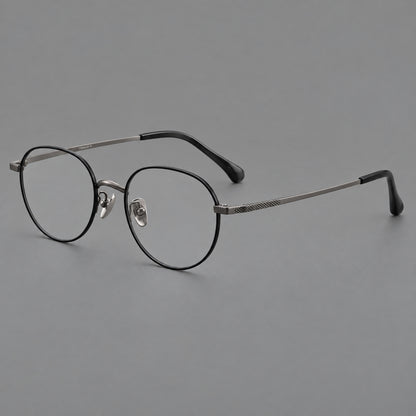 Compact round titanium glasses with an arched bridge and textured temple accents in Black and Gunmetal, three quarter view front view