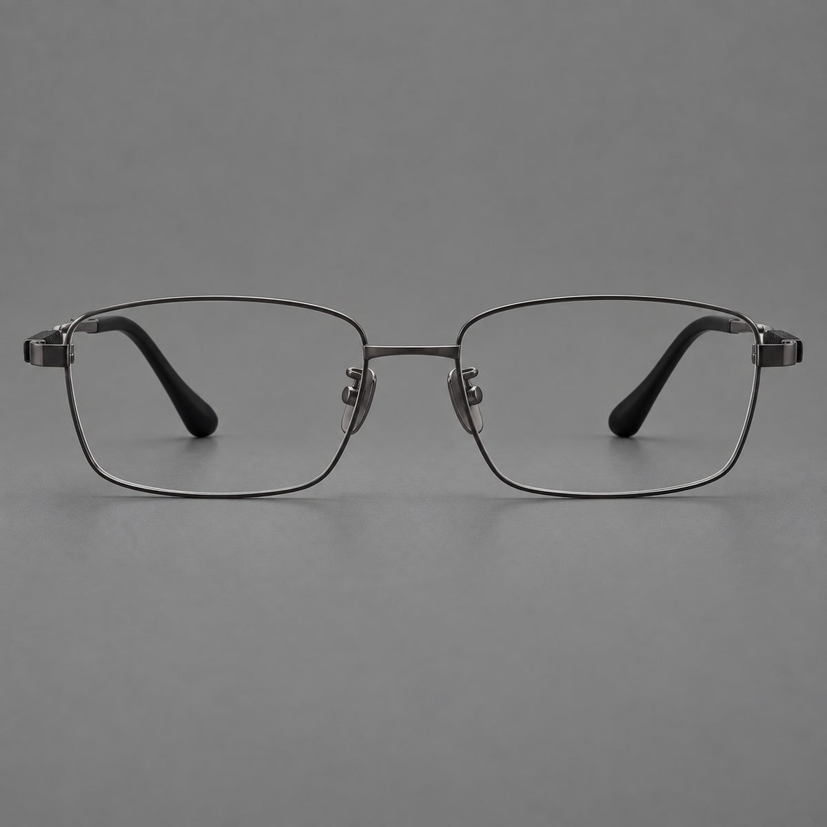 Slim rectangular titanium glasses with broad temples and contrasting dark inserts in Gunmetal, front view