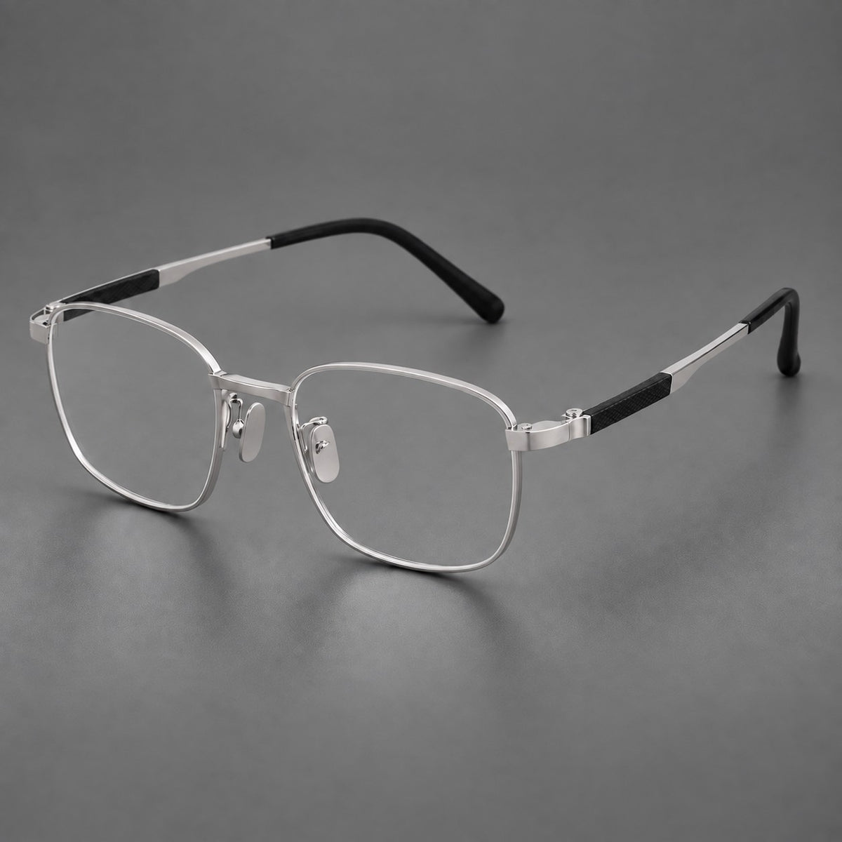 Slim rectangular titanium glasses with broad temples and contrasting dark inserts in Silver, three quarter view