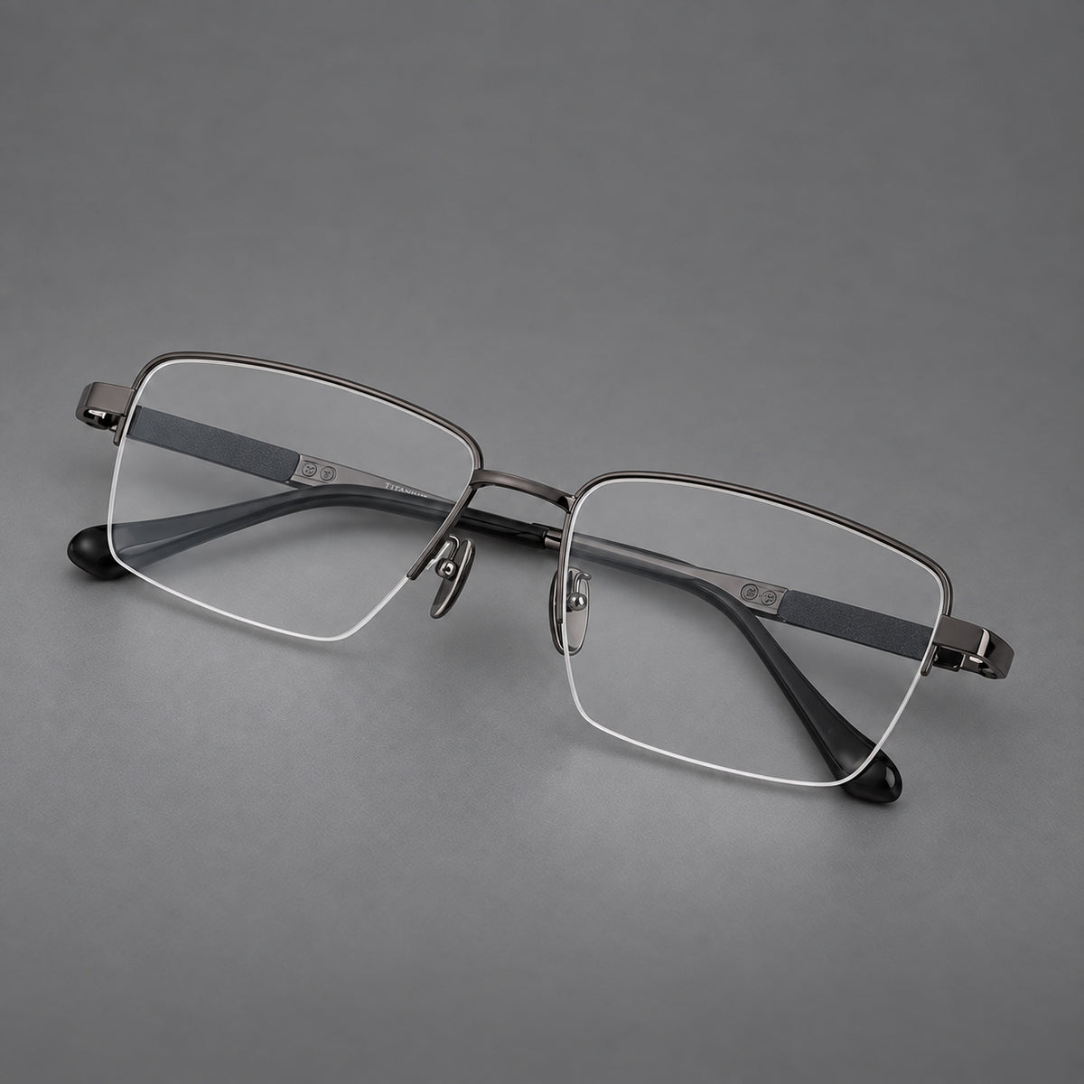 Wide half frame titanium glasses with rectangular lenses and textured temples in Gunmetal, three quarter view